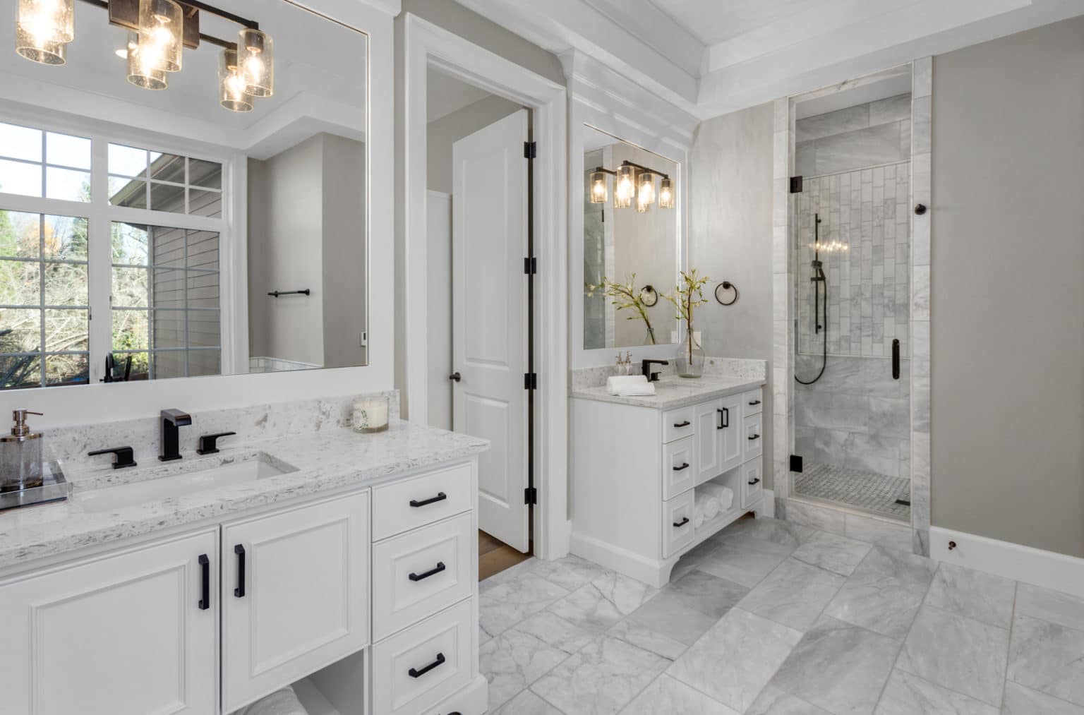 Beautiful bathroom in new luxury home with two vanities, sinks, and mirrors.