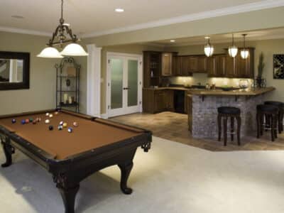 A basement that was turned into an extra room for entertaining with a pool table and kitchen.