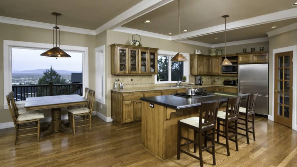 Wooden floors with wooden kitchen cabinets in this newly remodeled kitchen in Utah. 