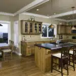 Wooden floors with wooden kitchen cabinets in this newly remodeled kitchen in Utah.
