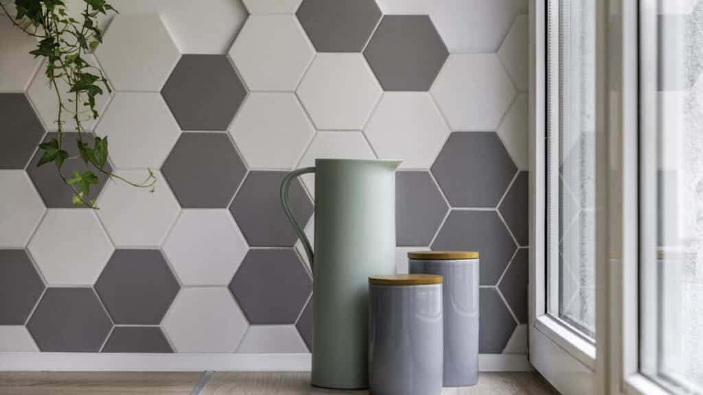 A gray and white hexagon tile accent wall in a new home addition.