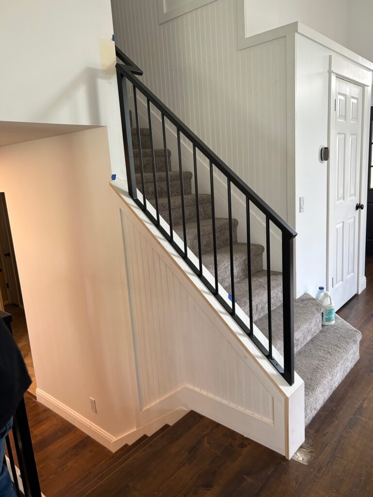 A side view of a new metal handrail and carpet added to this Draper, Utah home remodel.