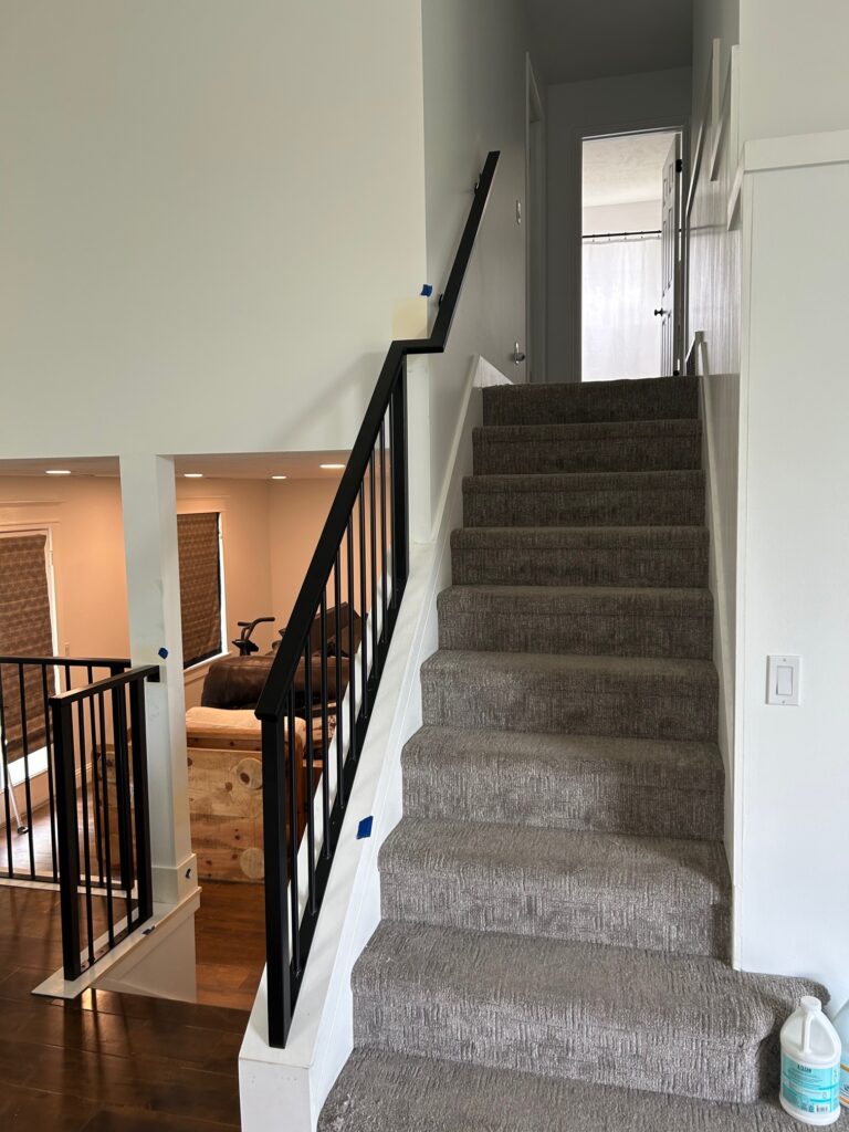 New metal handrail and carpet added to this Draper, Utah home remodel.