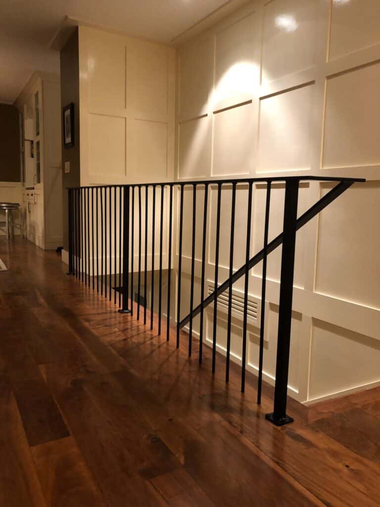 New wooden floors and metal handrails installed in this Draper, Utah home by Allied Remodeling Contractors. 
