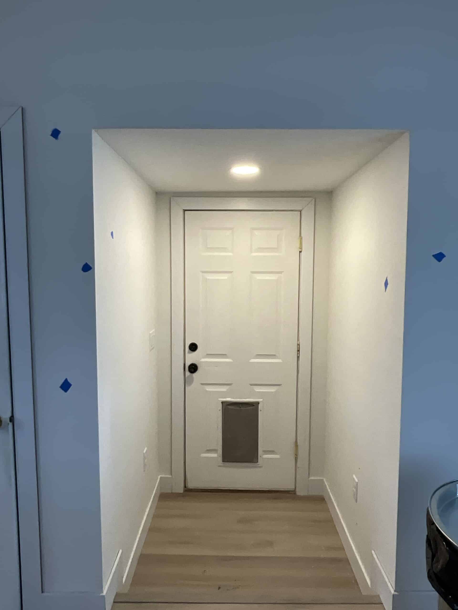 Finished entry way to this newly remodeled kitchen with a doggie door.. The homeowner went with white and blue accent for the paint.