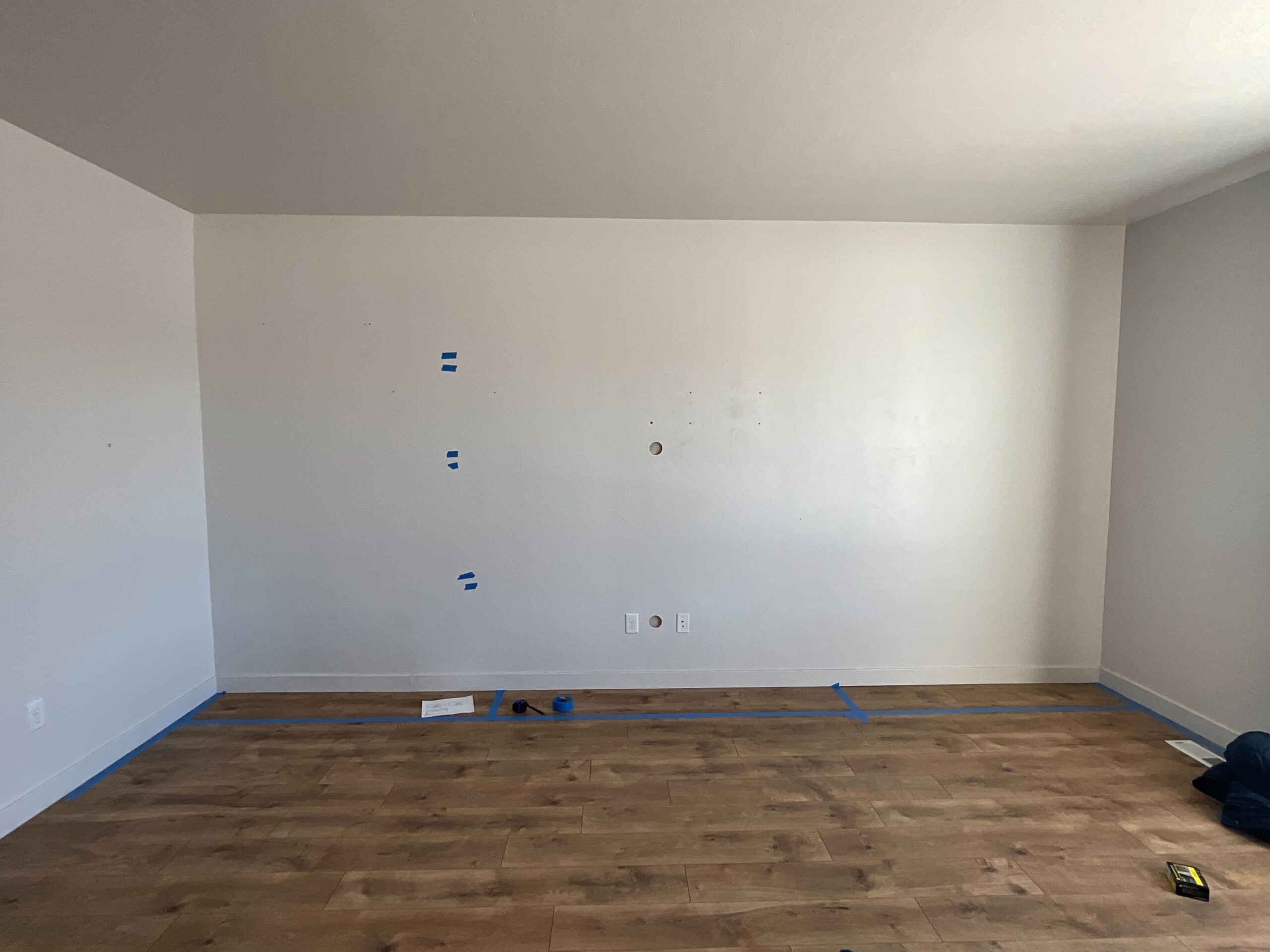 Before photo of a living room that Allied Remodeling Contractors in Lehi, Utah is remodeling. The finished project will include a fireplace and built in entertainment center.