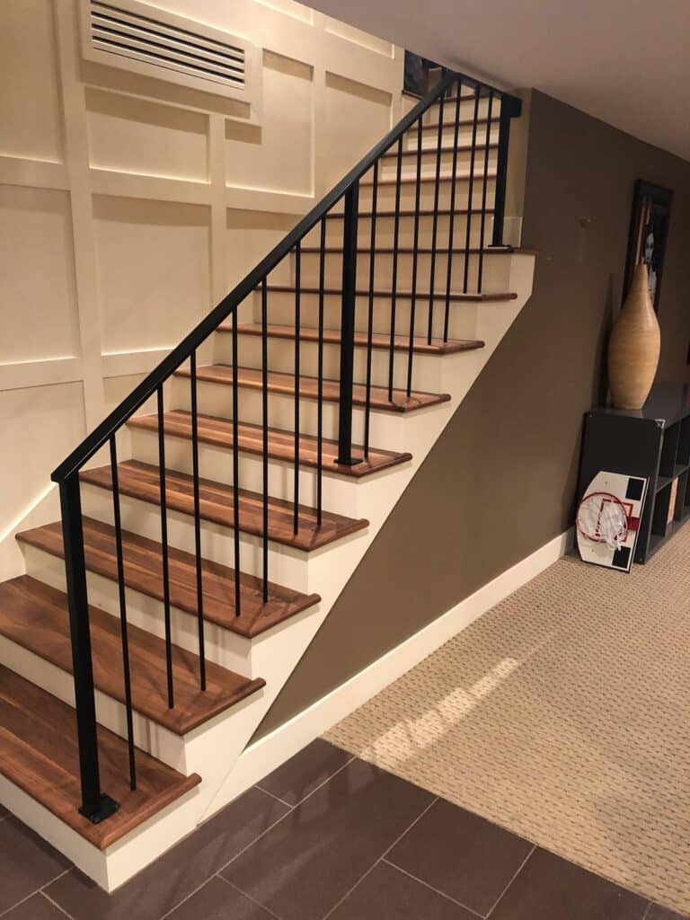 New wooden staircase, floors, and metal handrails installed in this Draper, Utah home by Allied Remodeling Contractors. 