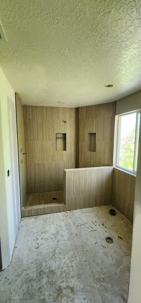 The old shower and bathtub have been removed and the new ones have been added. This master bathroom remodel in Pleasant Grove is moving along and read for bathroom tile. 