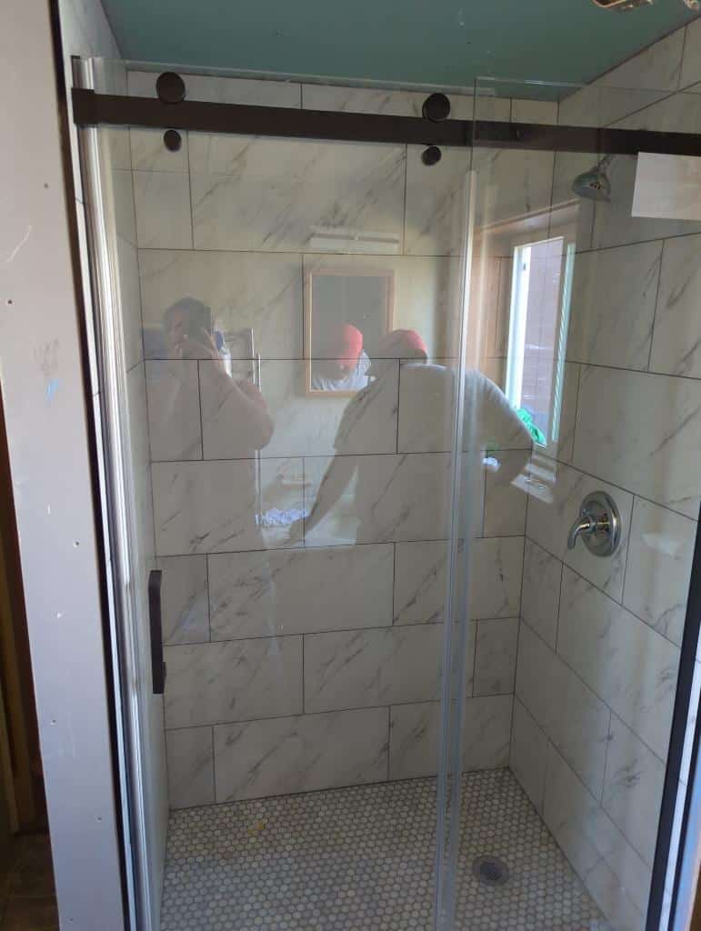 This is the completed modern shower remodel. New tile and glass shower door installed. 