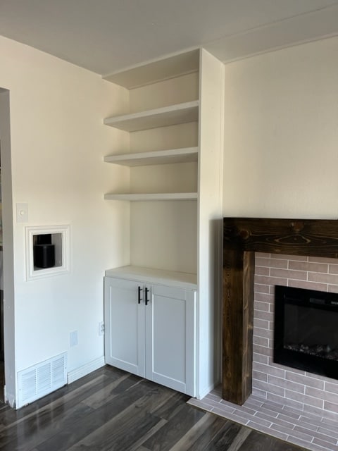 This fireplace remodel included a built in cabinet with shelves. 