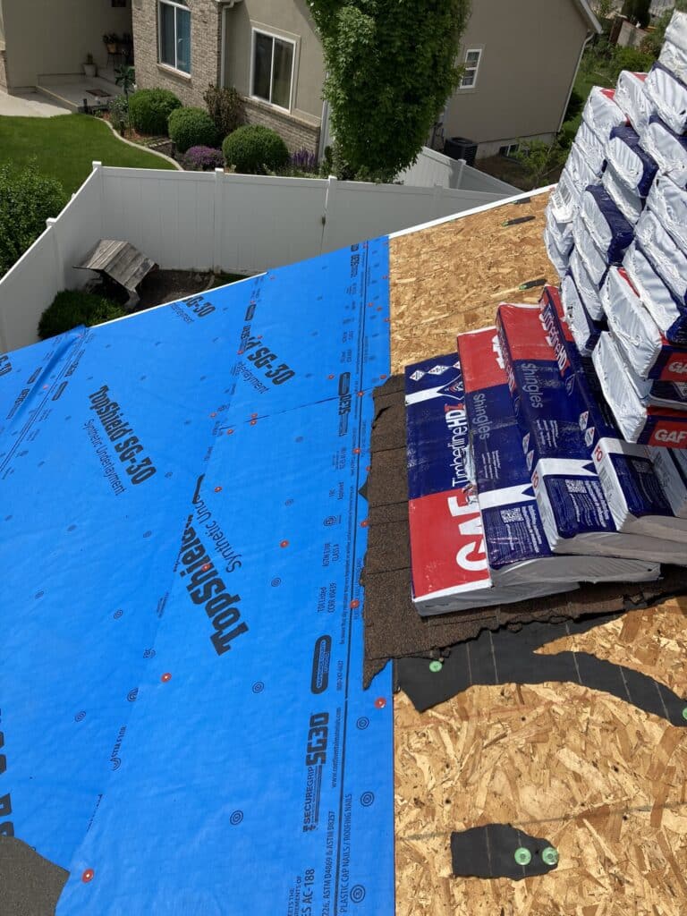 Underlayment and waterproofing layers are being added to this new roof being installed in Lehi, Utah. 