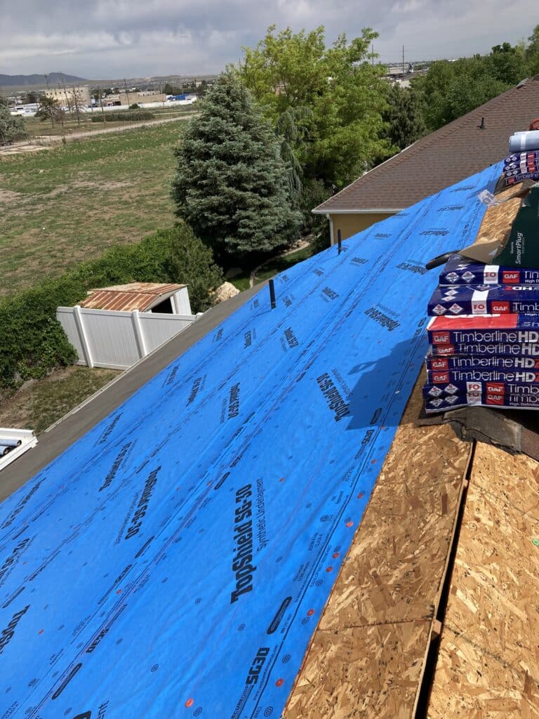 Laying Henry® Blueskin® RF200: A self-adhered rubberized waterproof roofing membrane underlayment for slope roofs under shingles, cedar shakes, and select metal/tiles.