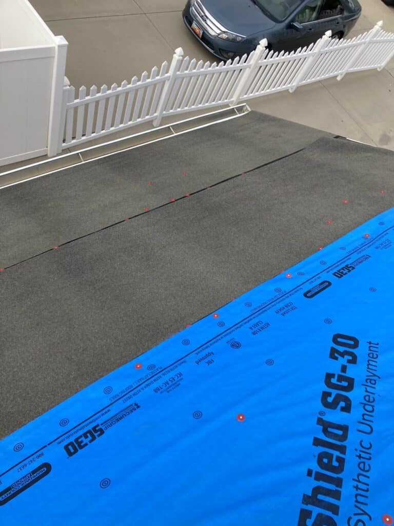 "Laying Henry® Blueskin® RF200: A self-adhered rubberized waterproof roofing membrane underlayment for slope roofs under shingles, cedar shakes, and select metal/tiles."