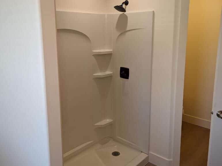 This is a white shower installation shower insert completed by Allied Remodleing Contractors.