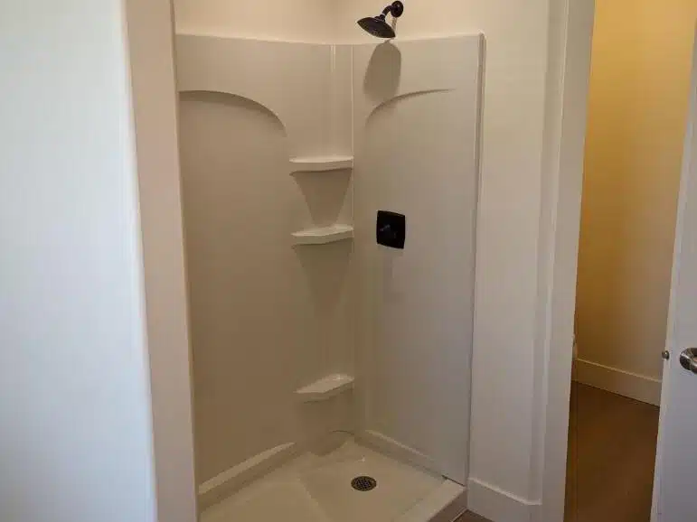 This is a white shower installation shower insert completed by Allied Remodleing Contractors.