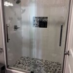 Walk in shower with tile surround and tile flooring