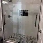 Walk in shower with tile surround and tile flooring