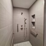 Remodeled a tub to a stand-up shower with several faucet heads and tiled surround
